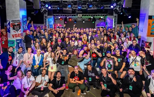 A crowd posing for a group photo at a Magic Box event
